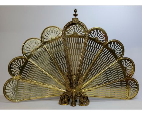 A substantial early 20th century brass 'peacock' firescreen, with mythical Griffin and lion paw base, excellent condition. 