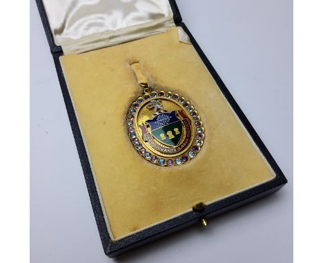 Local interest - a 9ct gold and enamel medallion, the obverse mounted with enamelled Sheffield coat of arms and set with ligh