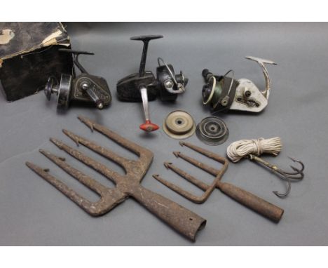 A cast eel fork together with a later example and three fixed spool reels to include a Alcock Delmatic and a J.W. Young &amp;