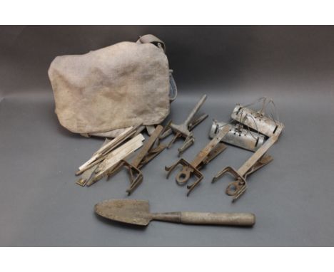 A mole trapping kit consisting of two tunnel traps, four scissor traps, trowel, markers, bag etc.