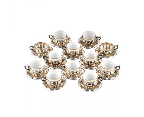 Baroque silver coffee service of twelve cups and saucers, and ten porcelain inserts. The total weight of the products is 1596