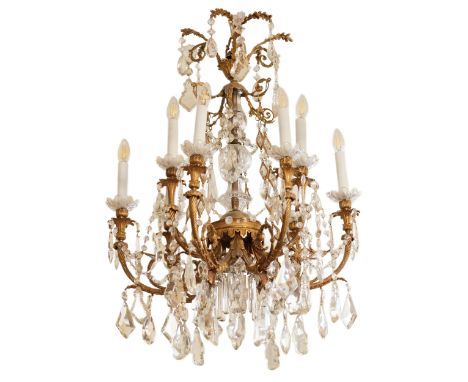 Richly decorated, bronze chandelier with high curves for nine candles, with Louis XVI style crystal bodywork. The central rod