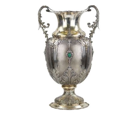 Large, amphora-shaped, silver vase in rich floral decoration. Follows the idea of a cornucopia, with an abundant pattern of a