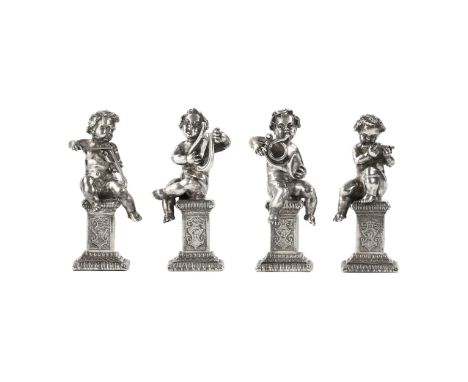 Four funny figures of putti musicians sitting on columnar pedestals and giving a chamber concert on the lyre, violin, flute a