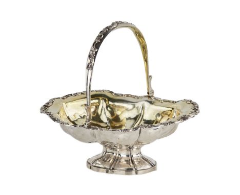 Russian silver oval rusk bowl with a handle on swivels and a corrugated surface of the body. With applied roccaille decoratio