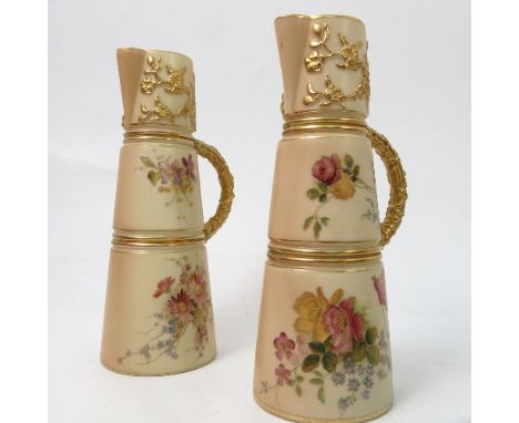 A pair of Royal Worcester blush ivory claret jugs, decorated with flowers, shape number 1047, circa 1906 and 1907, height 8in