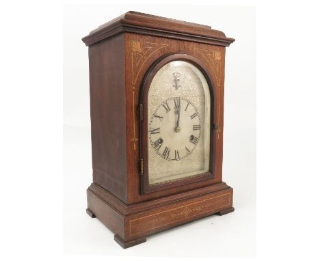 A 20th century mahogany cased mantel clock, with Westminster chiming movement, the silvered dial with engraved decoration, th