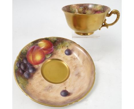 A Royal Worcester cabinet teacup and saucer, decorated to the saucer and to the interior of the cup by Freeman, with hand pai