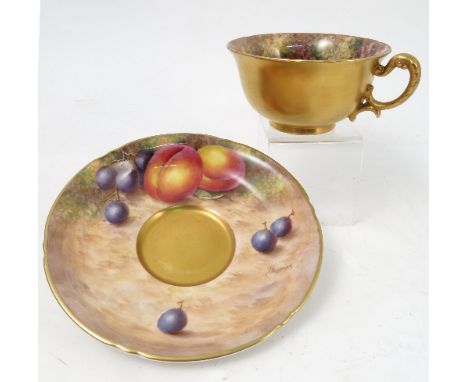 A Royal Worcester cabinet teacup and saucer, decorated to the saucer and to the interior of the cup by Freeman, with hand pai