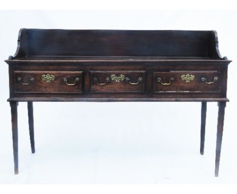 A 19th century oak three drawer dresser base, with a shelf superstructure over, raised on turned legs, width 60ins