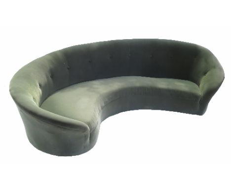 A green upholstered sofa, with buttoned graded curved form back, width approximately 101ins 