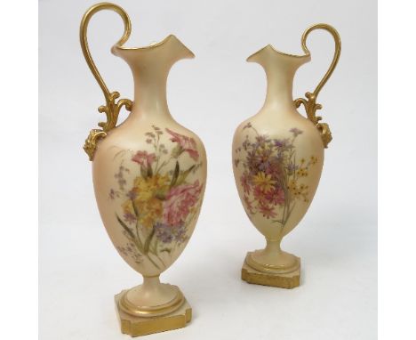 A pair of Royal Worcester blush ivory ewers, decorated with flowers, shape number 1944, circa 1903, height 9.25ins