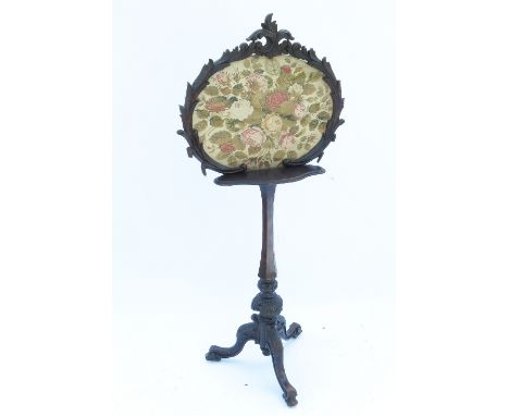 A rosewood screen stand, raised on a tripod base, with part carved knees