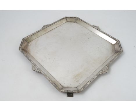 A silver square salver, decorated in the Art Deco manner, with canted corners, raised on four square stepped feet, Sheffield 