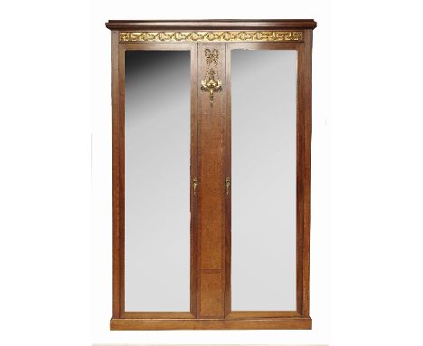 A Continental burr wood double mirror door wardrobe, with gilt metal mounts, to a Greek key frieze, raised on a plinth base, 