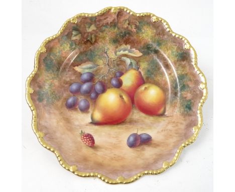 A Royal Worcester cabinet plate, decorated with hand painted fruit, by Ayrton, to a shaped gilded gadrooned border, diameter 