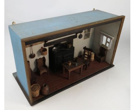 A child's dolls house kitchen, the single room fitted with a Victorian style metal range, with shelf over, cupboard, racks, t