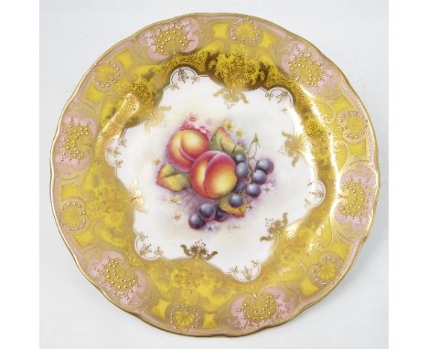 A Royal Worcester cabinet plate, decorated to the centre with a panel of hand painted fruit, by R Lewis, to a shaped yellow a