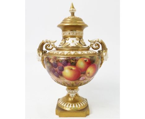 A Royal Worcester covered pedestal vase, decorated half round with hand painted fruit, by Ayrton, to mask handles, shape numb