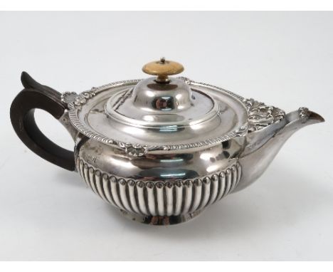 A silver tea pot, with gadrooned and shell edge to a gadrooned lower body, London 1902, maker Hutton and Sons Ltd, weight 11o