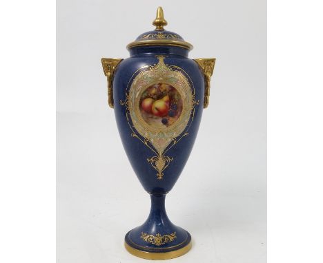 A Royal Worcester covered pedestal vase, decorated with a reserve panel of fruit, by Townsend, to a mottled blue ground, shap