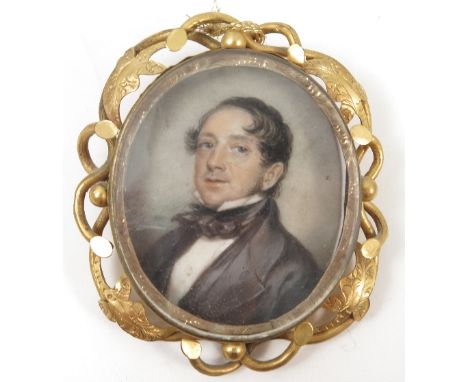 A 19th century oval portrait miniature, painted on ivory, of a man with black coat, maximum diameter 1.5ins, in a Victorian y