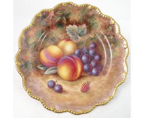 A Royal Worcester cabinet plate, decorated with hand painted fruit, by Ayrton, to a shaped gilded gadrooned border, diameter 