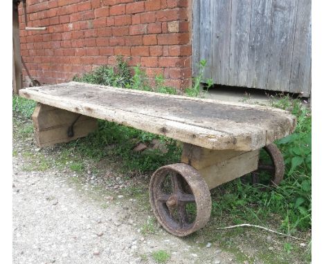 An Antique pig bench trolley, length 62ins 