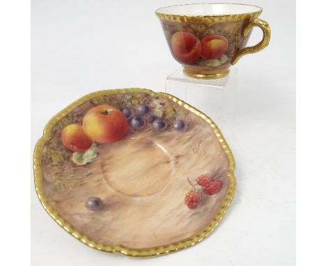 A Royal Worcester cabinet teacup and saucer, decorated to the saucer and exterior of the cup with hand painted fruit, by Love