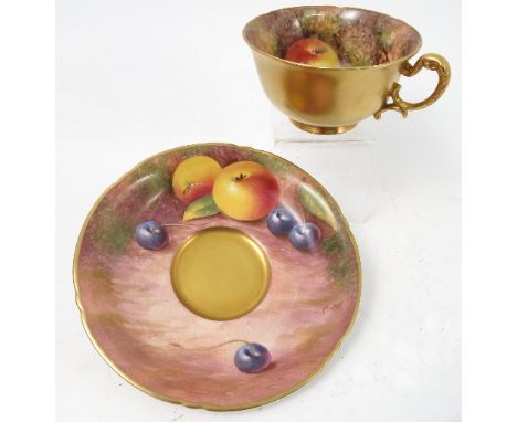 A Royal Worcester cabinet teacup and saucer, decorated to the saucer and to the interior of the cup by Freeman, with hand pai