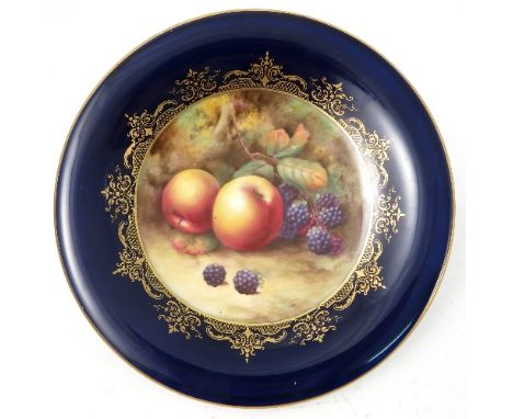 A Royal Worcester tazza, decorated with hand painted fruit, by H Price, to a deep blue ground border, circa 1926, diameter 9.