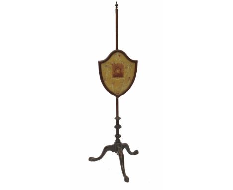 A 19th century mahogany pole screen, the shield shaped screen decorated with a printed portrait mounted on silk with material