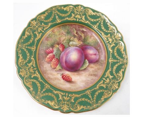 A Royal Worcester cabinet plate, decorated to the centre with a panel of hand painted fruit, by Townsend, to a deep green and