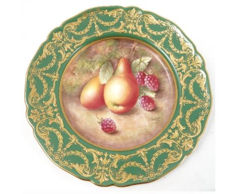 A Royal Worcester cabinet plate, decorated to the centre with a panel of hand painted fruit, by Townsend, to a deep green and