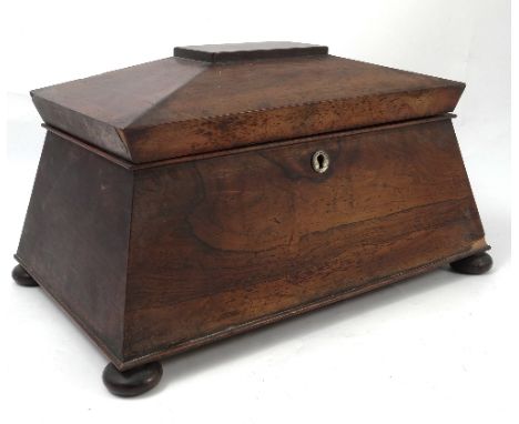 A 19th century rosewood tea caddy, of sarcophagus form, the interior fitted with two lift out boxes flanking a central well, 