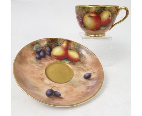 A Royal Worcester cabinet teacup and saucer, decorated to the saucer by Ayrton and to the exterior of the cup by Townsend, wi