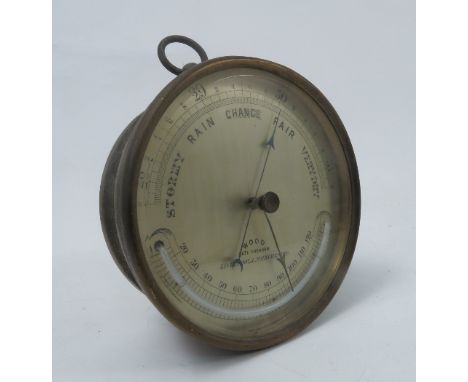 A Wood Late Abraham brass cased barometer, the circular case with silvered dial, mercury filled thermometer and temperature s