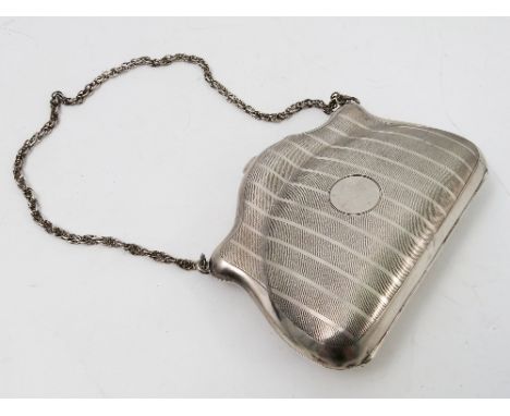 A ladies silver purse, with chain handle, engine turned decoration and leather lined interior, Birmingham 1914