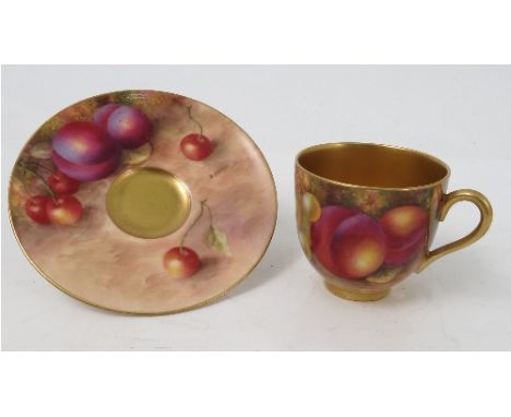 A Royal Worcester cabinet coffee cup and saucer, decorated to the saucer and exterior of the cup with hand painted fruit, by 