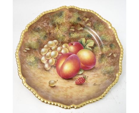 A Royal Worcester cabinet plate, decorated with hand painted fruit, by Freeman, to a shaped gilded gadrooned edge, diameter 1