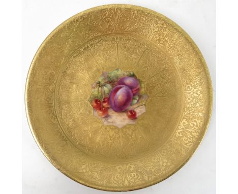 A Royal Worcester cabinet plate, decorated to the centre with a panel of hand painted fruit, by Freeman, to a deep acid gilt 