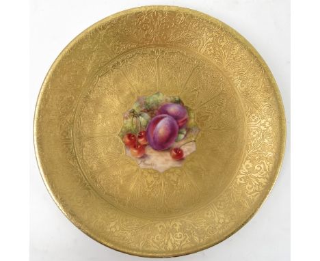 A Royal Worcester cabinet plate, decorated to the centre with a panel of hand painted fruit, by Freeman, to a deep acid gilt 