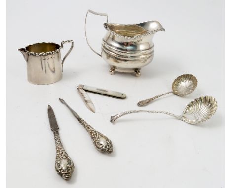 A silver jug, with gadrooned edge, waisted body and raised on ball feet, marks rubbed, weight 3oz, together with another silv