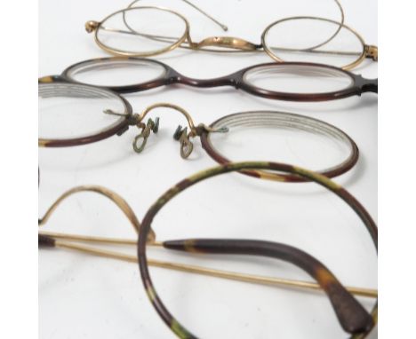 A collection of spectacles, with yellow metal and faux tortoiseshell frames, together with various brass and enamel dress stu