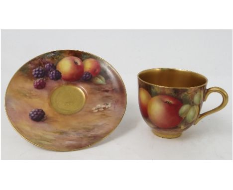 A Royal Worcester cabinet coffee cup and saucer, decorated to the saucer with hand painted fruit by Price and to the exterior