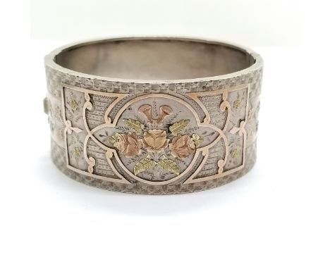 Antique unmarked silver and gold bangle, interior diameter 5cm, 2.8cm wide, in overall good used condition. 26.5g total 