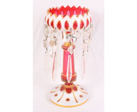 A ruby and white cameo glass table lustre hung glass drops, 10" high