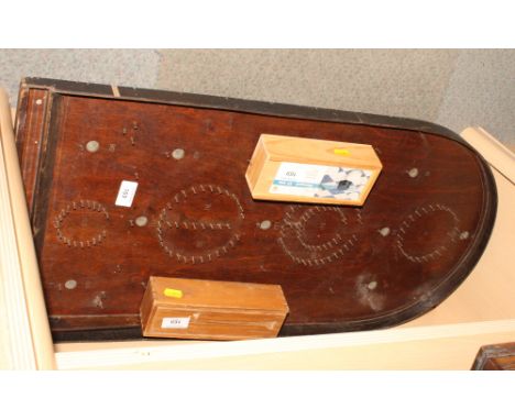 A bagatelle board and a boxed set of dominoes and draughts