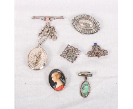 A Victorian silver locket on chain, a similar silver brooch, a silver brooch with miniature portrait and four other silver br