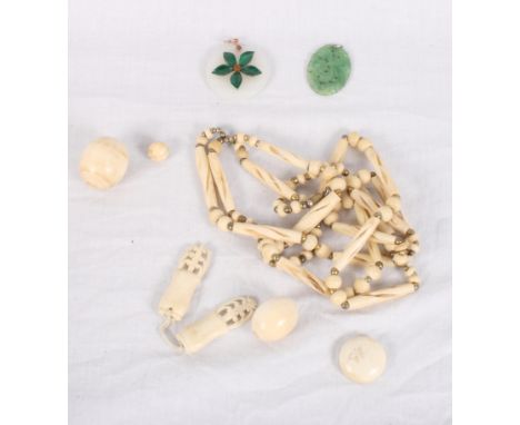 A malachite and jade flower pendant with gold mount, a Chinese carved jadeite pendant, two large ivory beads and other ivory 